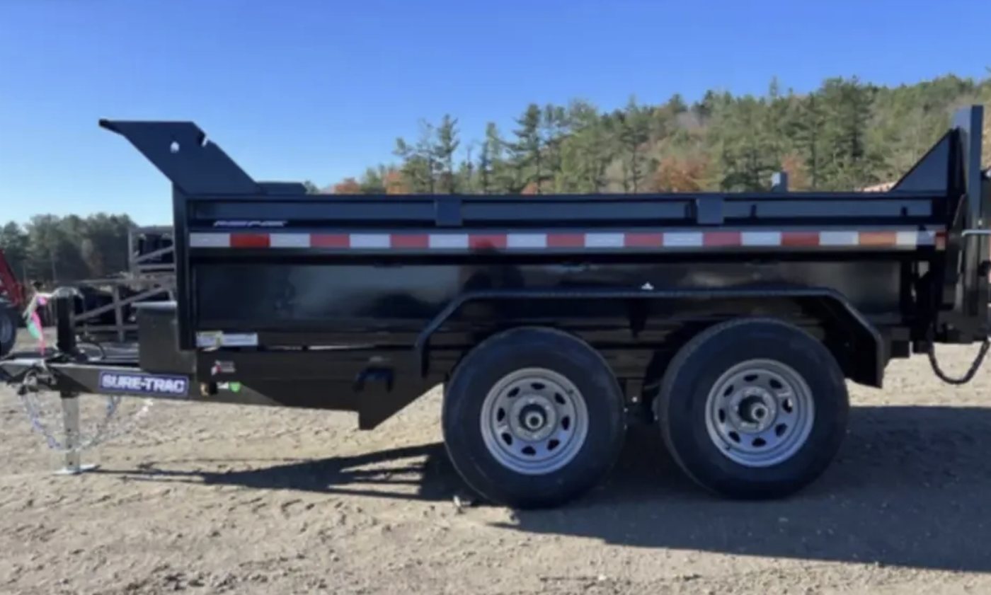 Black 6 by 10 foot dump trailer with dual axles