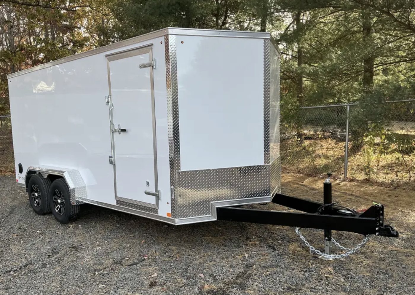 White 7 by 16 foot enclosed trailer with a side door
